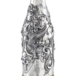 Handcrafted by the florentine master goldsmith Giuliano Foglia, this isa detail of Fantasy Champagne bottle cover that has intricately chiseled a series of surrealistic images