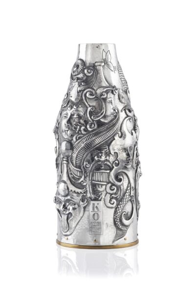 Handcrafted by the florentine master goldsmith Giuliano Foglia, this isa detail of Fantasy Champagne bottle cover that has intricately chiseled a series of surrealistic images
