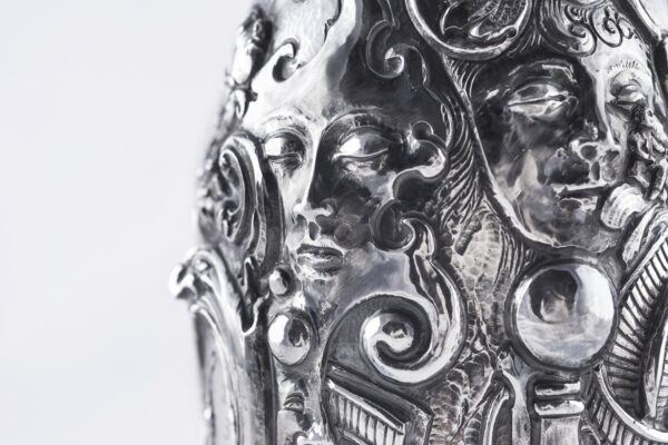 Handcrafted by the florentine master goldsmith Giuliano Foglia, this isa detail of Fantasy Champagne bottle cover that has intricately chiseled a series of surrealistic images