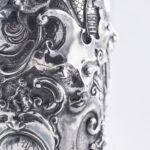 Handcrafted by the florentine master goldsmith Giuliano Foglia, this isa detail of Fantasy Champagne bottle cover that has intricately chiseled a series of surrealistic images