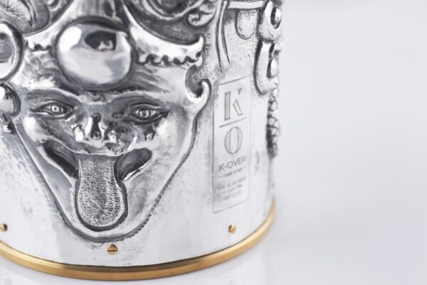Handcrafted by the florentine master goldsmith Giuliano Foglia, this isa detail of Fantasy Champagne bottle cover that has intricately chiseled a series of surrealistic images