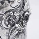 Handcrafted by the florentine master goldsmith Giuliano Foglia, this isa detail of Fantasy Champagne bottle cover that has intricately chiseled a series of surrealistic images