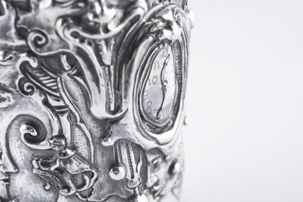 Handcrafted by the florentine master goldsmith Giuliano Foglia, this isa detail of Fantasy Champagne bottle cover that has intricately chiseled a series of surrealistic images