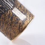 Detail of champagne bottle cover, engraved forest scene in autumn colors.