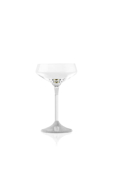 Elegant coupe glass with a clear, wide bowl and a sleek silver metal stem. The base features a textured finish with a small engraved logo, blending modern design with refined craftsmanship.