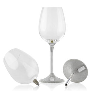 Couple of wine glass with a sleek, modern design. The clear glass cup sits atop a slim metal stem, which transitions into a textured, silver-finished base featuring a small plaque engraved with the word 'KOVER'.
