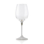 Single wine glass with a sleek, modern design. The clear glass cup sits atop a slim metal stem, which transitions into a textured, silver-finished base featuring a small plaque engraved with the word 'KOVER'.