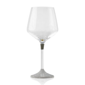 Single wine glass with a sleek, modern design. The clear glass cup sits atop a slim metal stem, which transitions into a textured, silver-finished base featuring a small plaque engraved with the word 'K-OVER'.