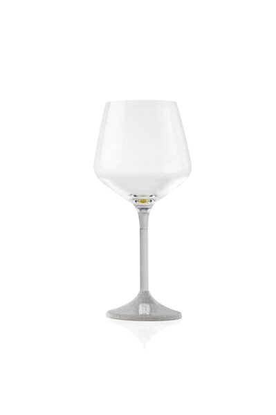 Single wine glass with a sleek, modern design. The clear glass cup sits atop a slim metal stem, which transitions into a textured, silver-finished base featuring a small plaque engraved with the word 'K-OVER'.