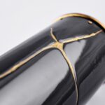Detail of the Wine bottle cover Kintsugi Wine - Japan Memories: elegant black wine bottle cover inspired by the Japanese art of Kintsugi, with delicate gold cracks enhancing its surface, symbolizing beauty in imperfection and the value of unique stories