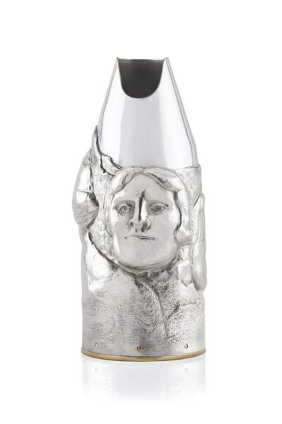 Artistic silver champagne bottle cover, finely engraved with expressive human faces emerging from textured surfaces, creating a sculptural effect that blends contemporary design and traditional craftsmanship.