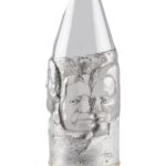 Artistic silver champagne bottle cover, finely engraved with expressive human faces emerging from textured surfaces, creating a sculptural effect that blends contemporary design and traditional craftsmanship.